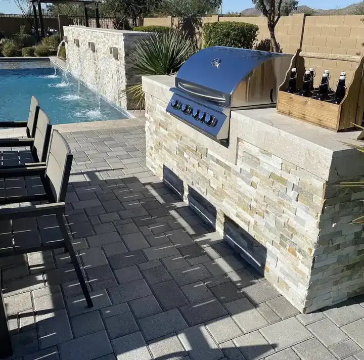 Outdoor kitchen next to a pool