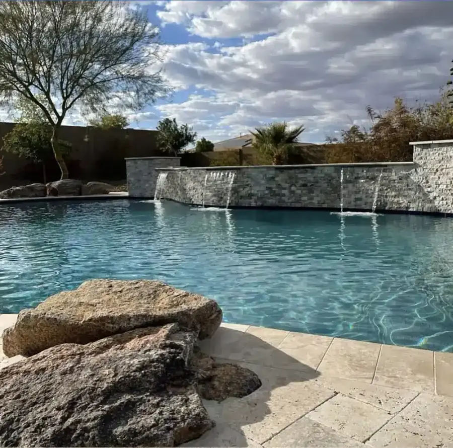 Pool with a stacked-stone waterfall wall